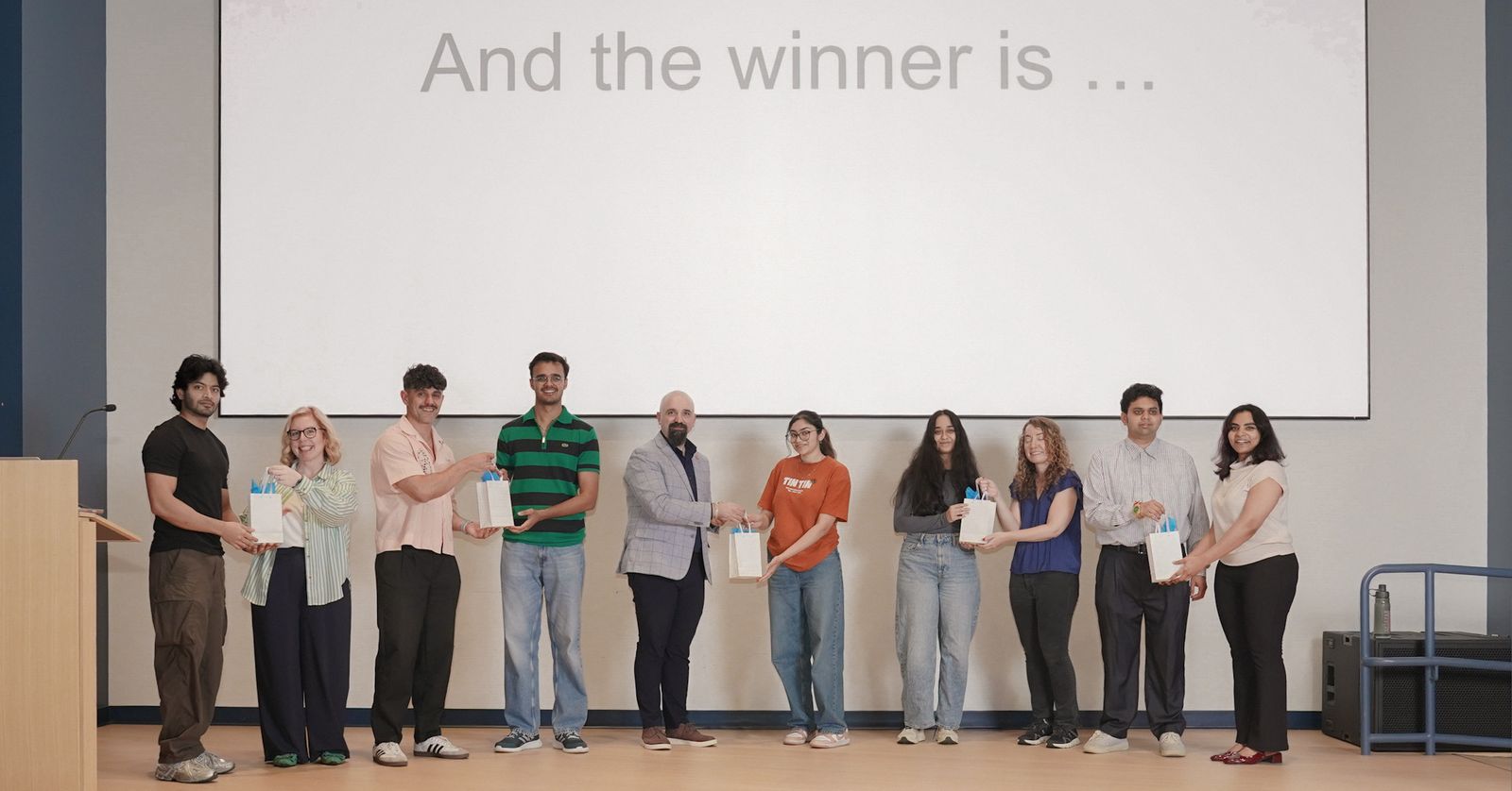 Winning teams receiving their prizes on stage